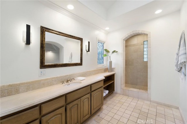 bathroom with vanity and tiled shower