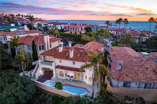 aerial view at dusk with a water view