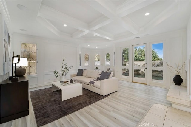 unfurnished living room featuring coffered ceiling, ornamental molding, beam ceiling, and light hardwood / wood-style flooring