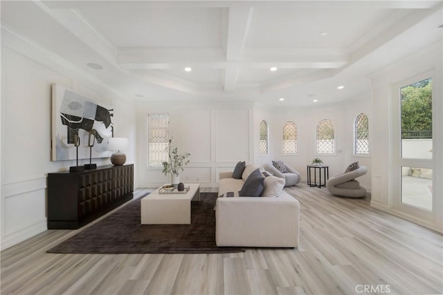 living room featuring coffered ceiling, crown molding, beamed ceiling, and light wood-type flooring