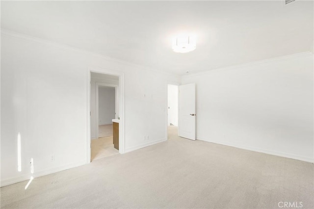 unfurnished room featuring light colored carpet and ornamental molding