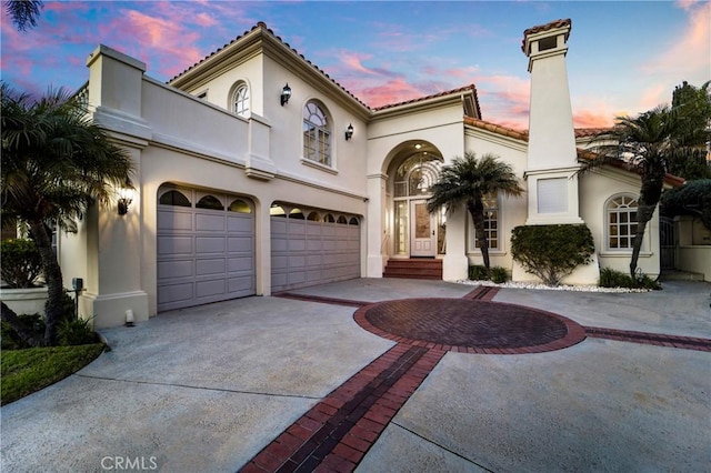 mediterranean / spanish home with a garage