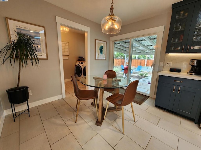 dining room with independent washer and dryer and light tile patterned flooring