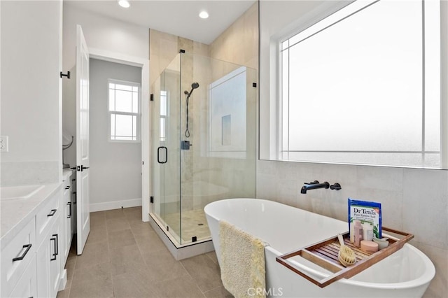 bathroom featuring vanity, tile patterned flooring, and separate shower and tub