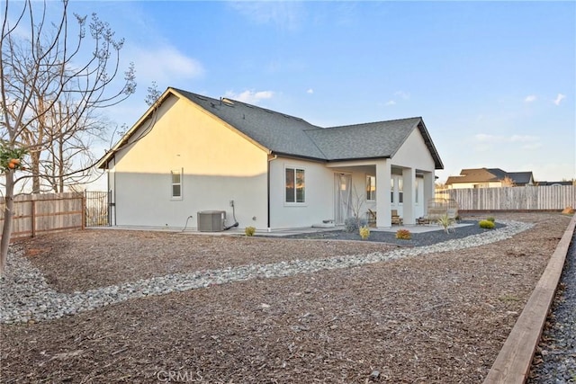 rear view of house with central AC unit