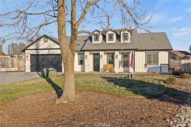 view of front of property featuring a garage and a front yard