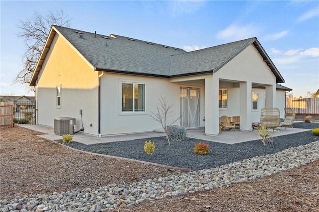 rear view of property with cooling unit and a patio area