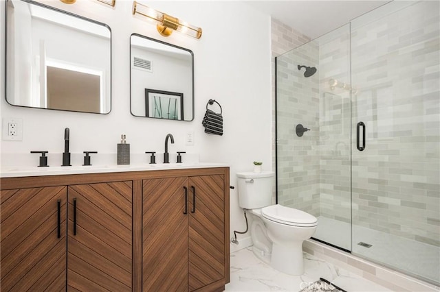 bathroom featuring vanity, toilet, and a shower with shower door