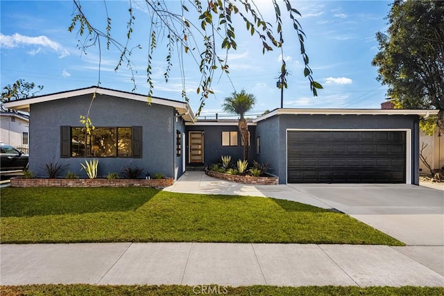 ranch-style home featuring a garage and a front yard