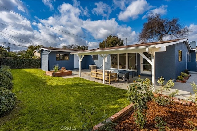 back of property with an outdoor hangout area, a lawn, and a patio area