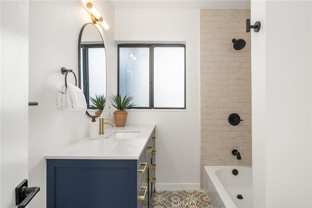 bathroom featuring vanity, tile patterned floors, and tiled shower / bath