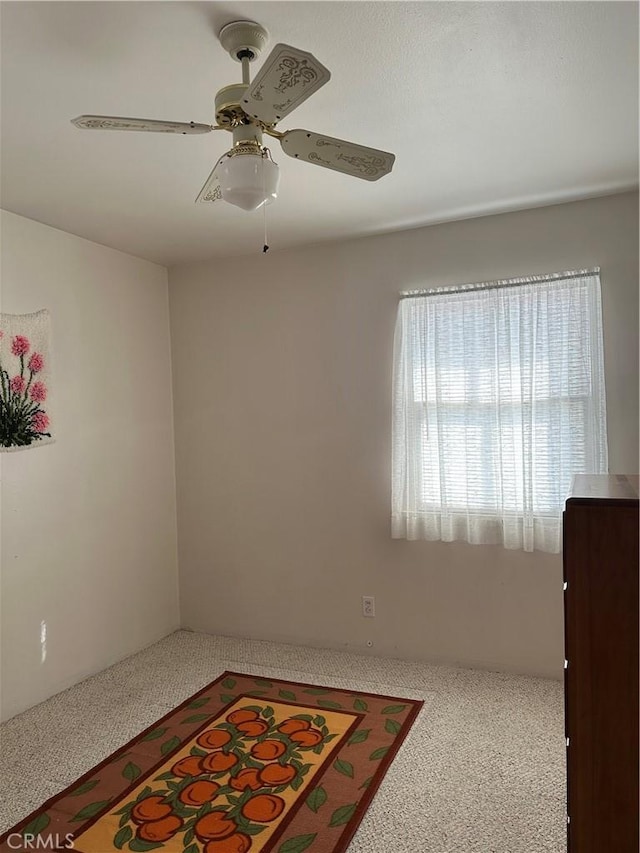 spare room with ceiling fan and carpet flooring