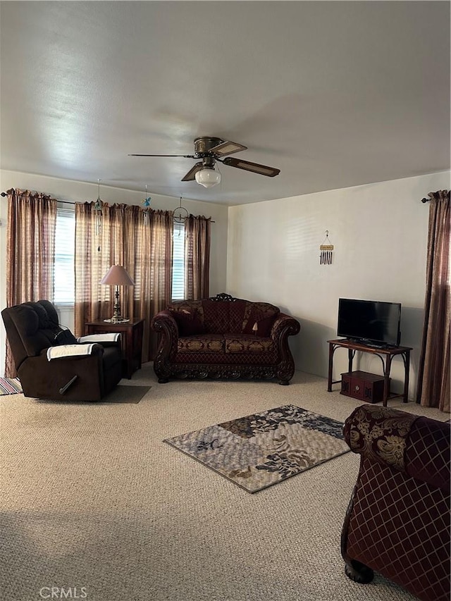 carpeted living room featuring ceiling fan