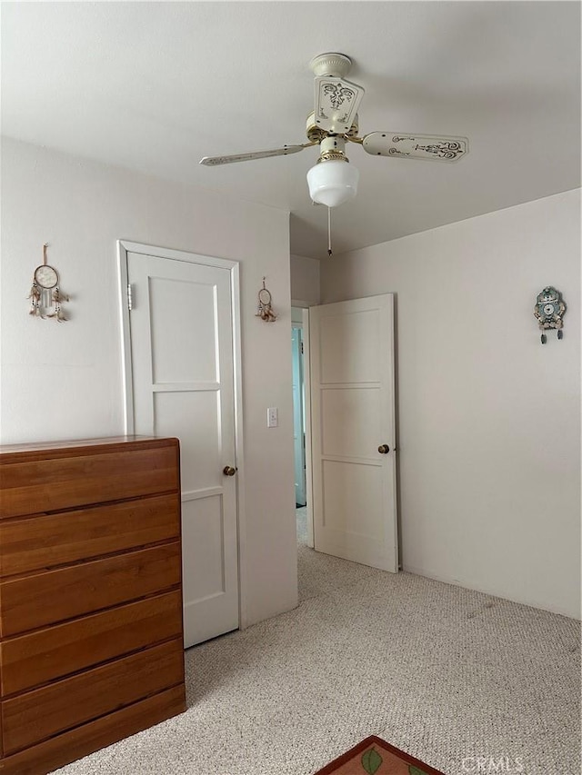 unfurnished bedroom with light carpet and ceiling fan