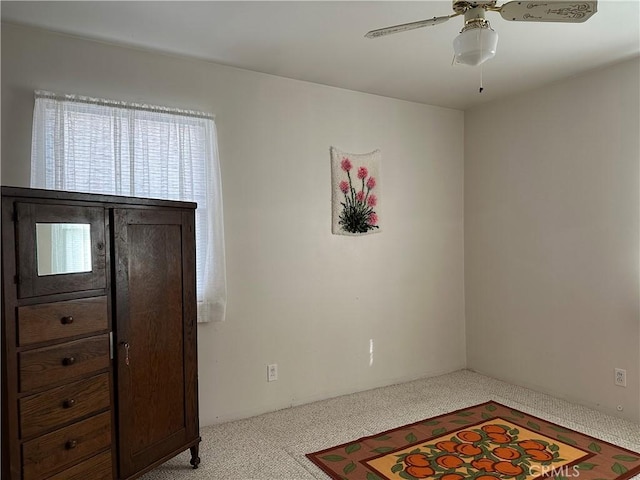 interior space featuring ceiling fan