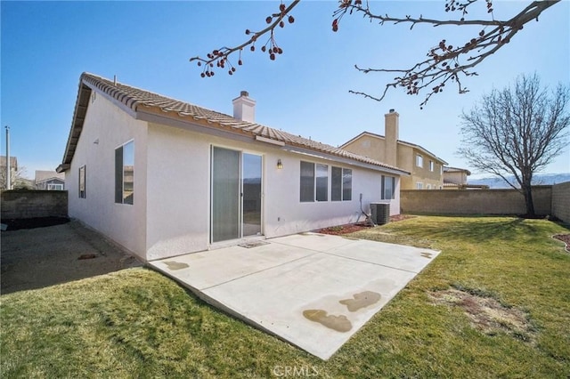 rear view of property with a patio, central AC unit, and a lawn