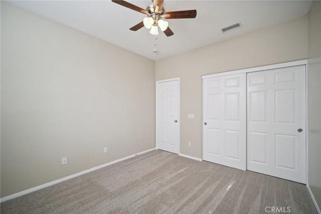 unfurnished bedroom featuring carpet, ceiling fan, and a closet