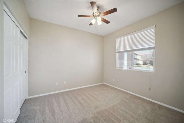 unfurnished bedroom featuring ceiling fan, a closet, and carpet