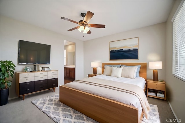 carpeted bedroom featuring ceiling fan and ensuite bathroom