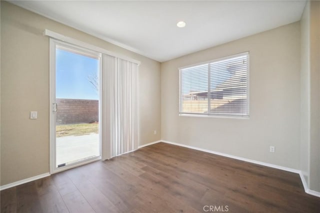 spare room with dark wood-type flooring