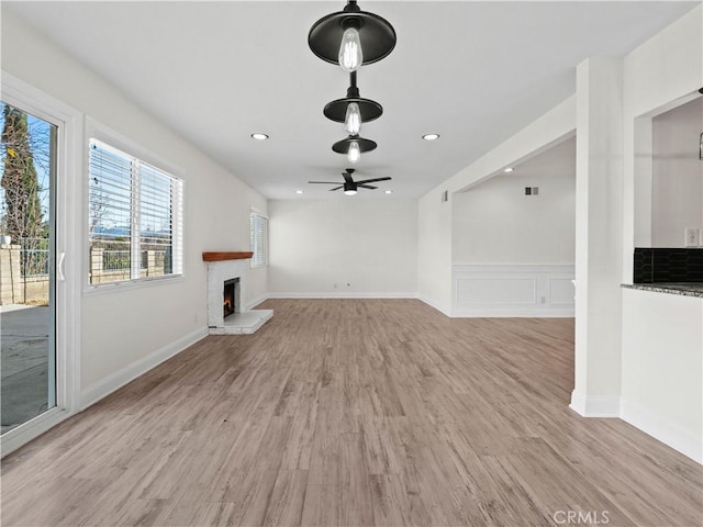 unfurnished living room with light hardwood / wood-style flooring and ceiling fan