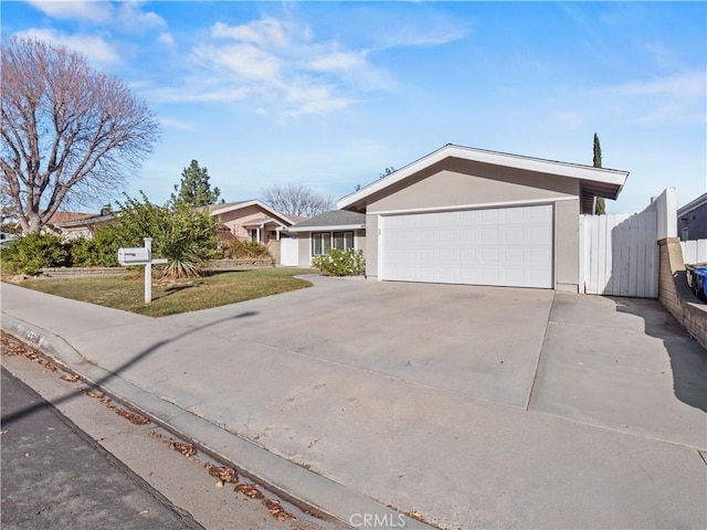 ranch-style home with a garage and a front yard