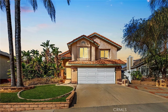 mediterranean / spanish-style house featuring a garage