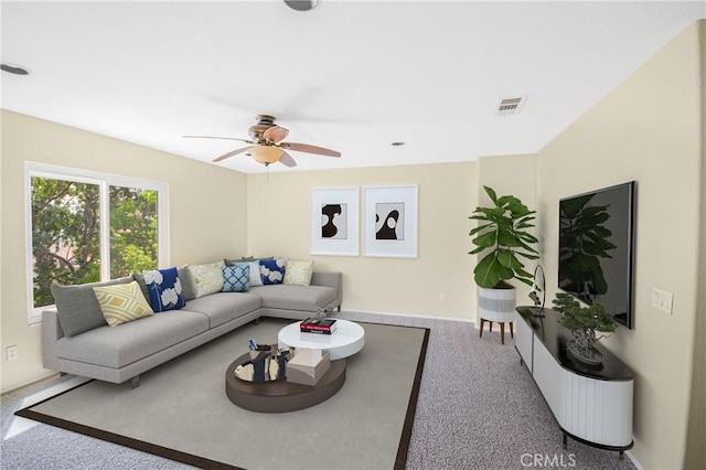 carpeted living room featuring ceiling fan