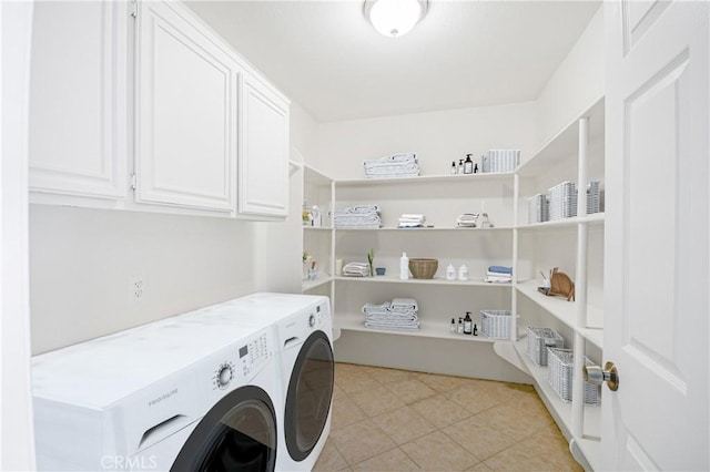 laundry room featuring cabinets, light tile patterned floors, and independent washer and dryer