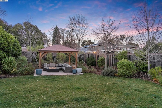 yard at dusk featuring a gazebo, outdoor lounge area, and a patio area