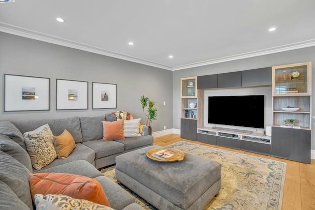 living room featuring crown molding, built in features, and light hardwood / wood-style floors