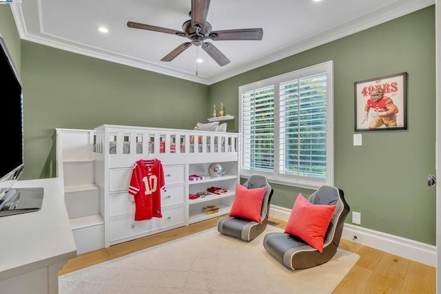 bedroom with ceiling fan, ornamental molding, and light wood-type flooring