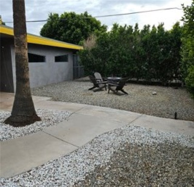 view of patio / terrace featuring an outdoor fire pit