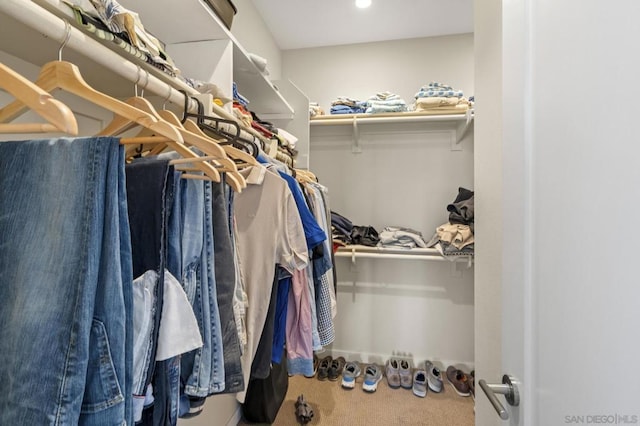 walk in closet with carpet floors