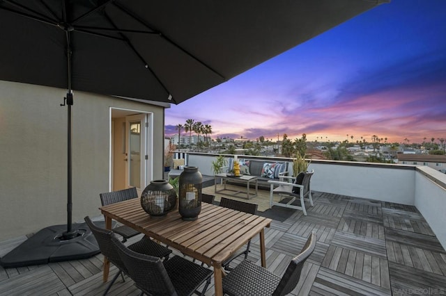 deck at dusk featuring outdoor lounge area