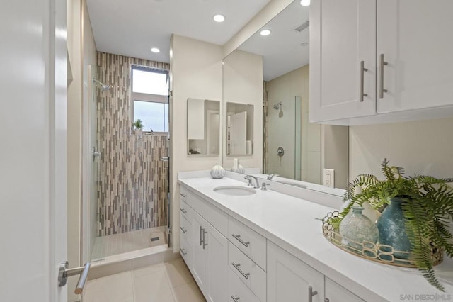 bathroom with tile patterned floors, vanity, and an enclosed shower