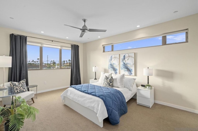 carpeted bedroom featuring ceiling fan and multiple windows