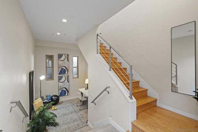 staircase with hardwood / wood-style flooring