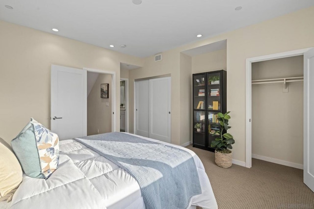 bedroom featuring two closets and light carpet