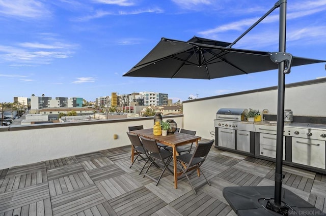 wooden deck featuring an outdoor kitchen and area for grilling