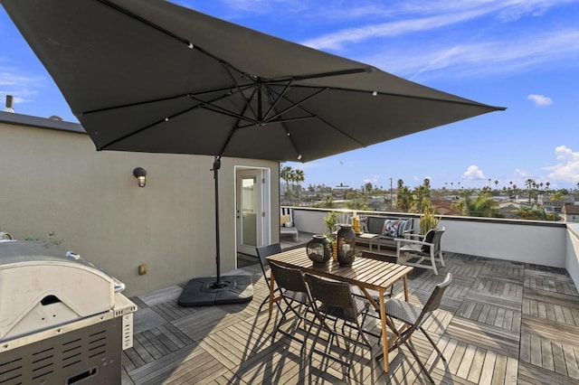 wooden deck featuring area for grilling