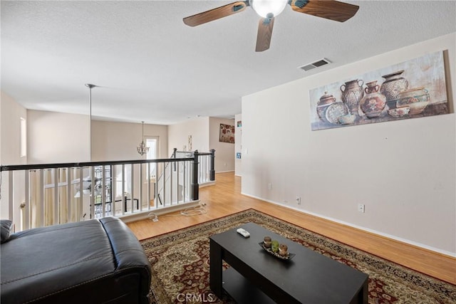 living room featuring a textured ceiling and light wood-type flooring