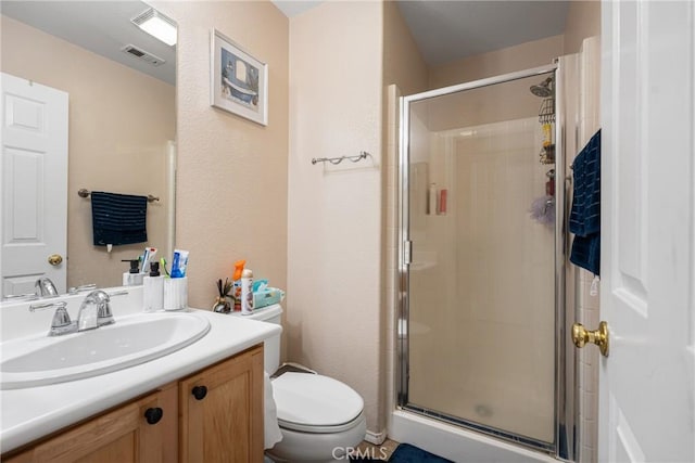 bathroom with vanity, an enclosed shower, and toilet