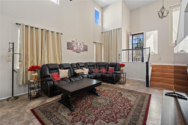 living room featuring light tile patterned floors, a towering ceiling, and a notable chandelier