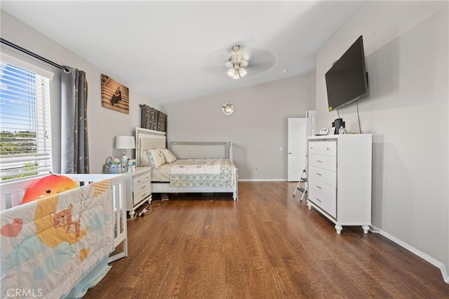 bedroom with dark wood-type flooring, vaulted ceiling, and ceiling fan