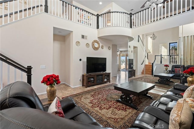 living room featuring a towering ceiling and tile patterned floors