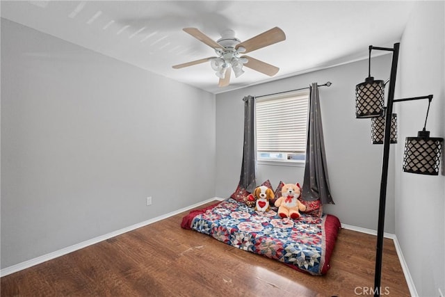 bedroom featuring dark hardwood / wood-style floors and ceiling fan