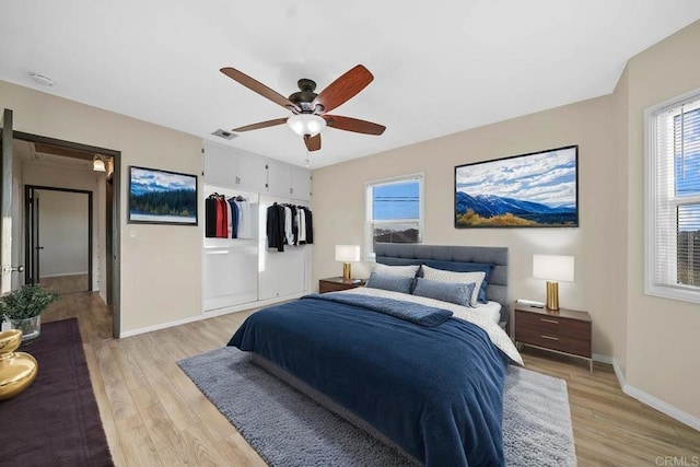 bedroom featuring a closet, ceiling fan, and light wood-type flooring