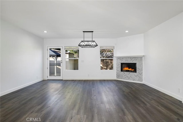 unfurnished living room with a tile fireplace and dark hardwood / wood-style floors