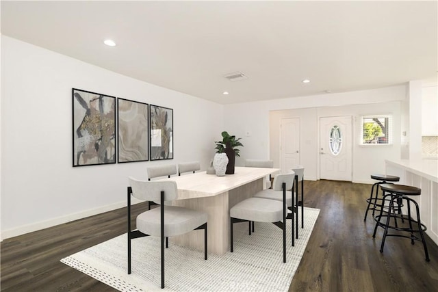 dining area with dark hardwood / wood-style flooring